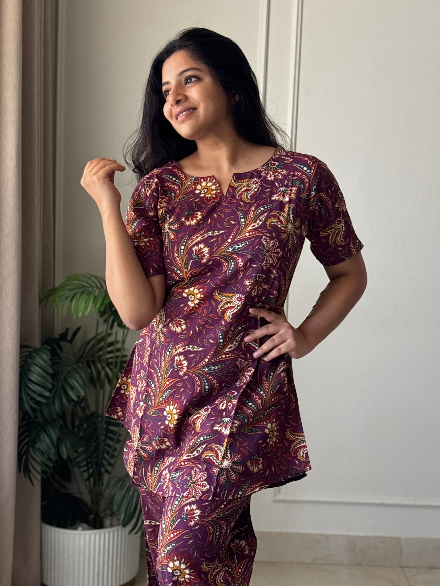 Close-up of the wine purple cotton nightwear set showing the detailed floral kalamkari print and comfortable short sleeves.