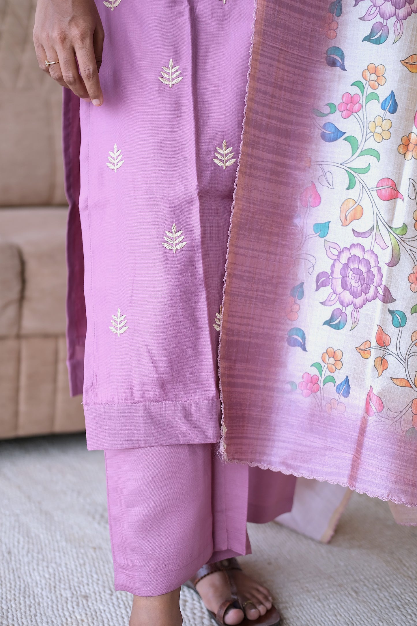 Detailed view of the straight-cut onion pink pants and the vibrant floral border of the dupatta.