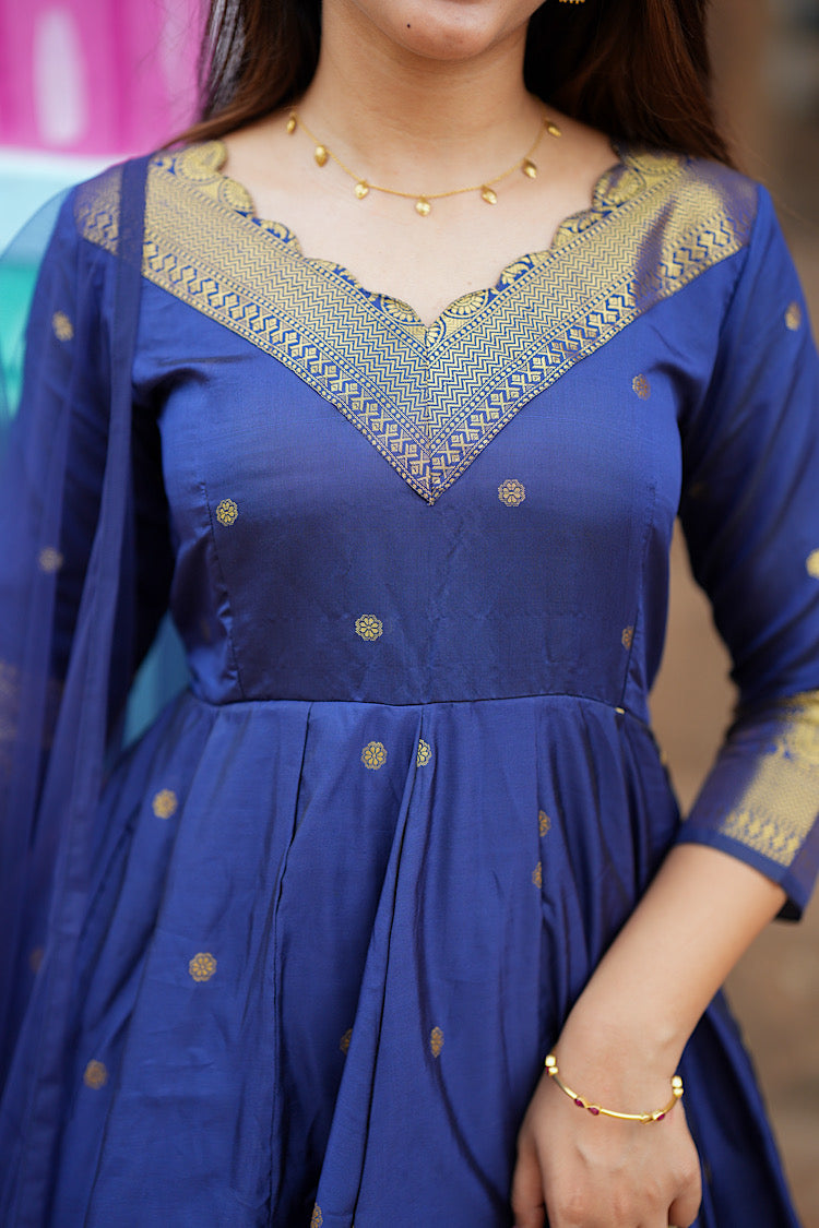 Close-up of the intricate gold zari scalloped V-neckline on the royal blue silk anarkali