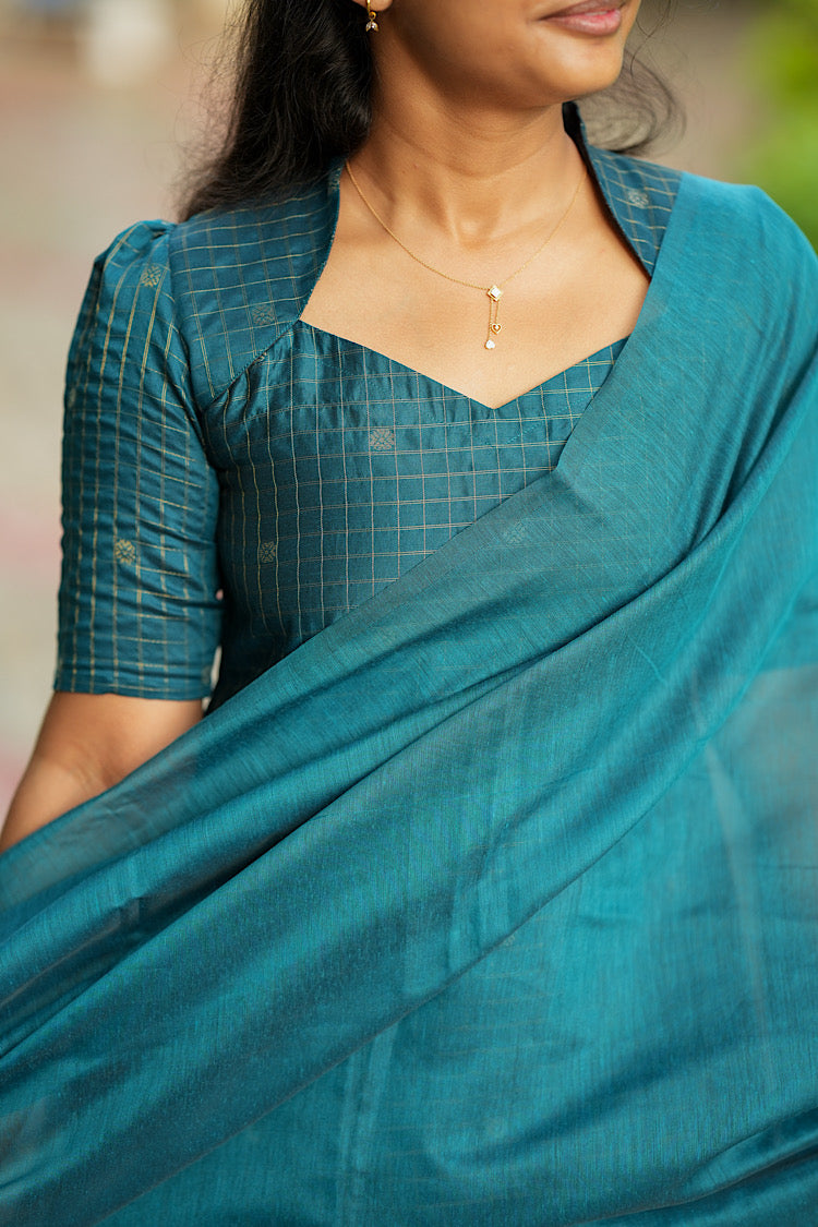 Close-up of Queen Anne neckline and gold zari check detailing