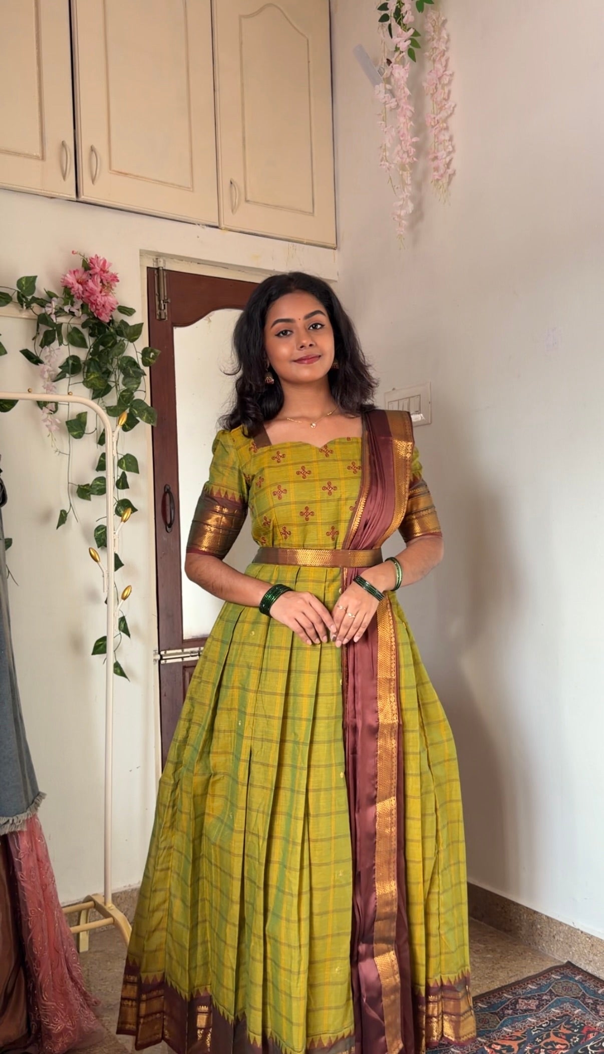 Tea green cotton anarkali dress styled with a maroon dupatta and a gold woven belt