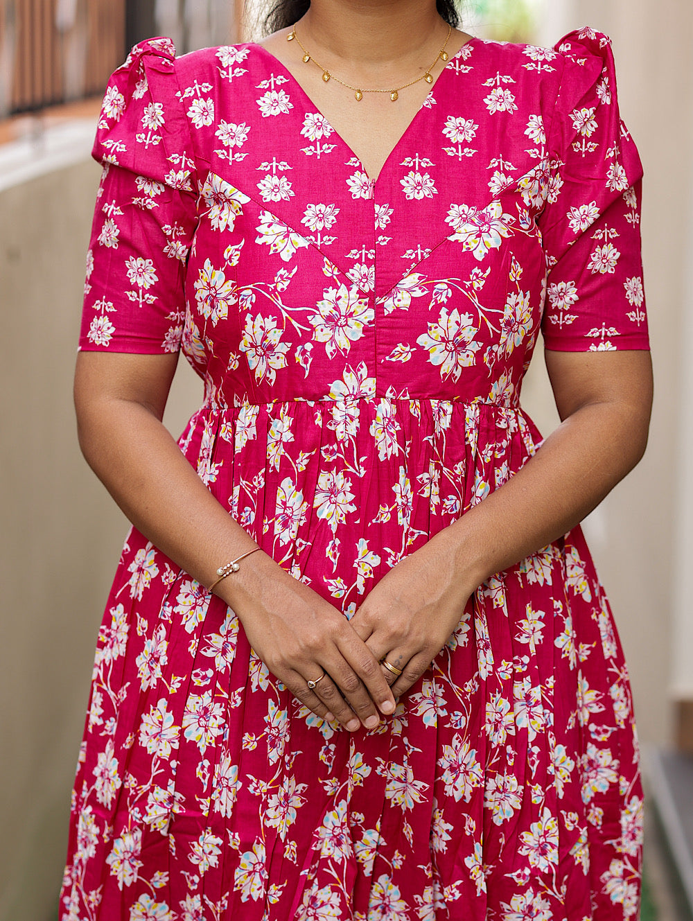 Close-up of the V-neckline and gathered bust area of the pink feeding nighty with zip.