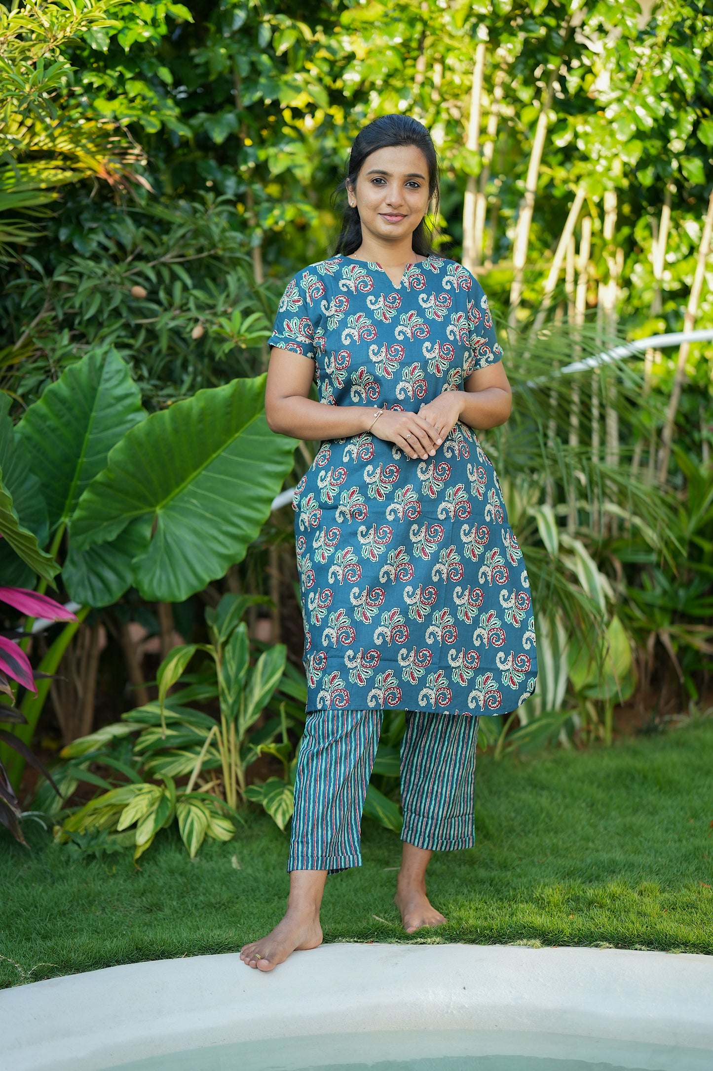 Comfortable teal green printed night suit with side pockets and relaxed fit pants.