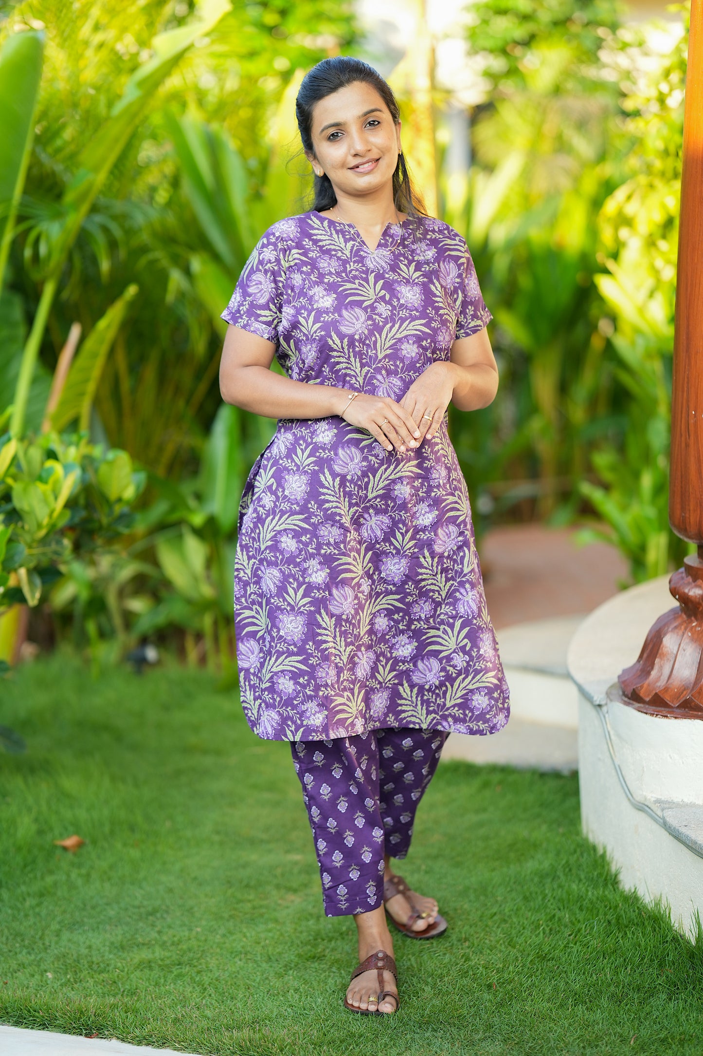Close-up of the purple printed cotton loungewear set showing the floral pattern and short sleeves.