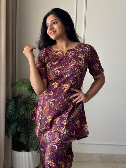 Close-up of the wine purple cotton nightwear set showing the detailed floral kalamkari print and comfortable short sleeves.