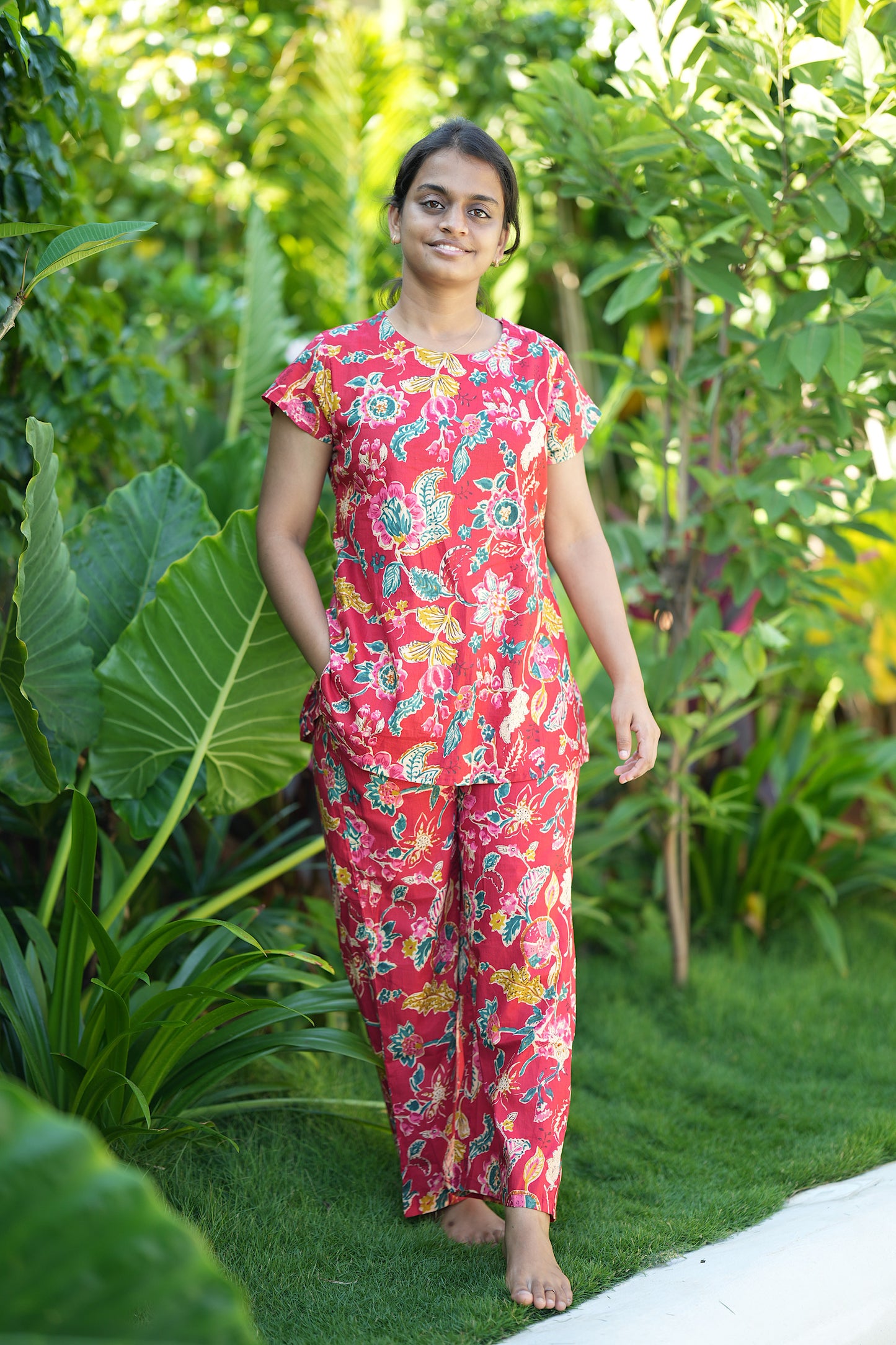 Red floral printed loungewear set showing a top with cap sleeves and pants with a convenient side pocket.