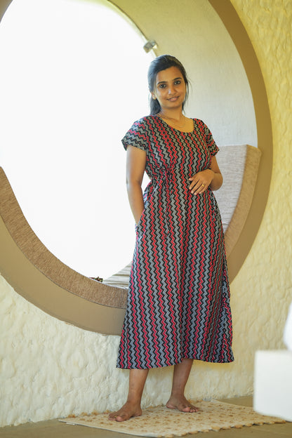 Comfortable cotton nighty with pockets in a black and red chevron print showing side pocket detail.