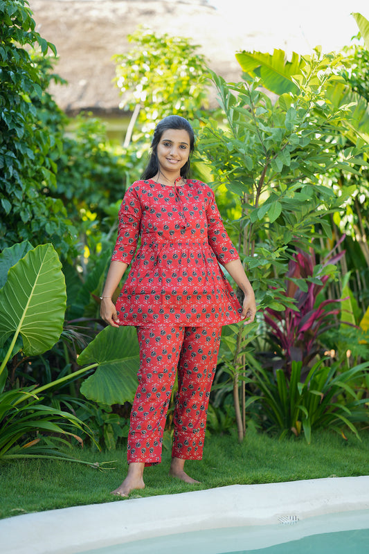 Close-up of the red peplum night suit showing the gathered waist detail and 3/4 sleeves.