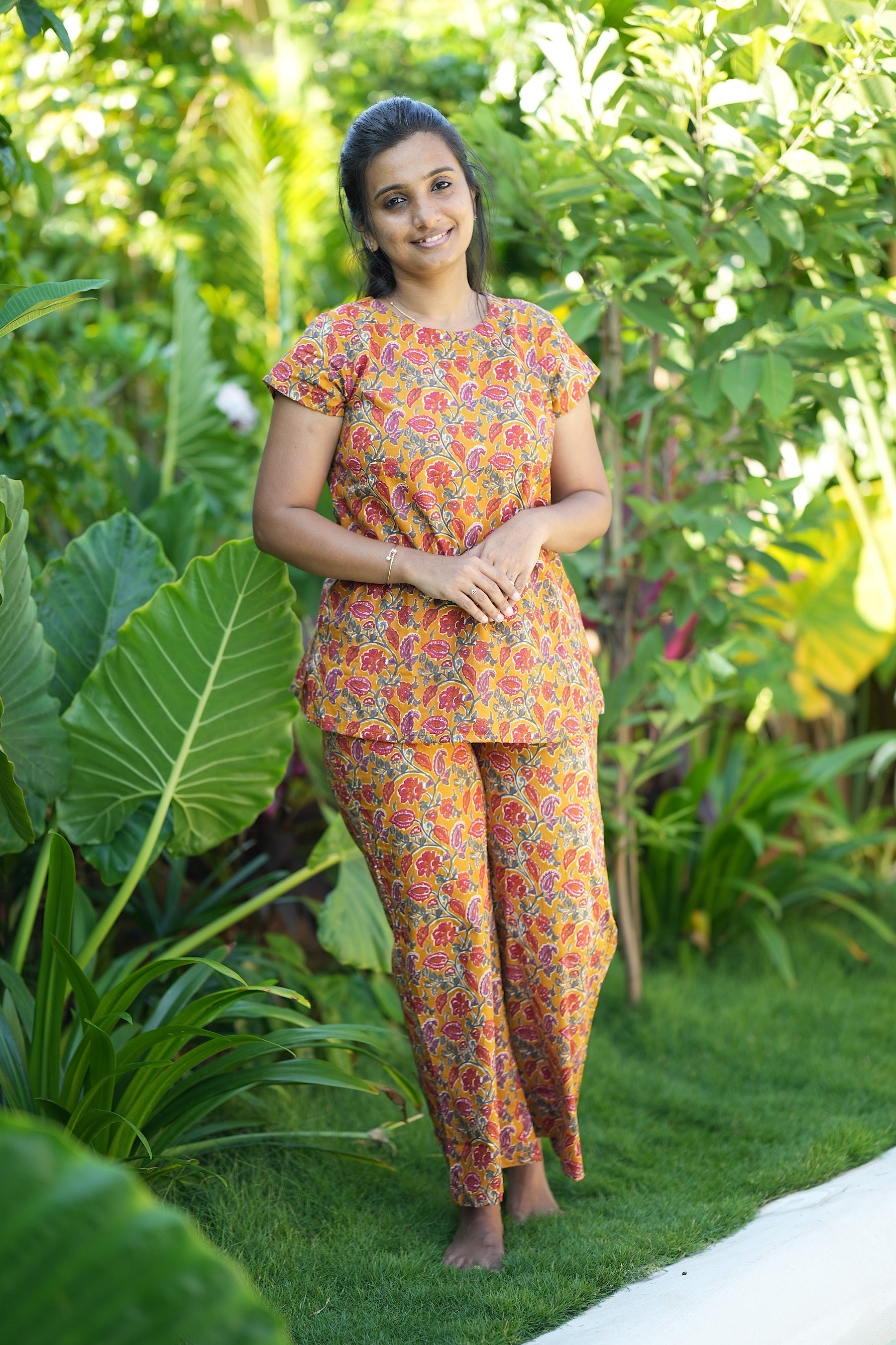 Comfortable ladies cotton loungewear set in mustard yellow floral print featuring cap sleeves and wide-leg pants