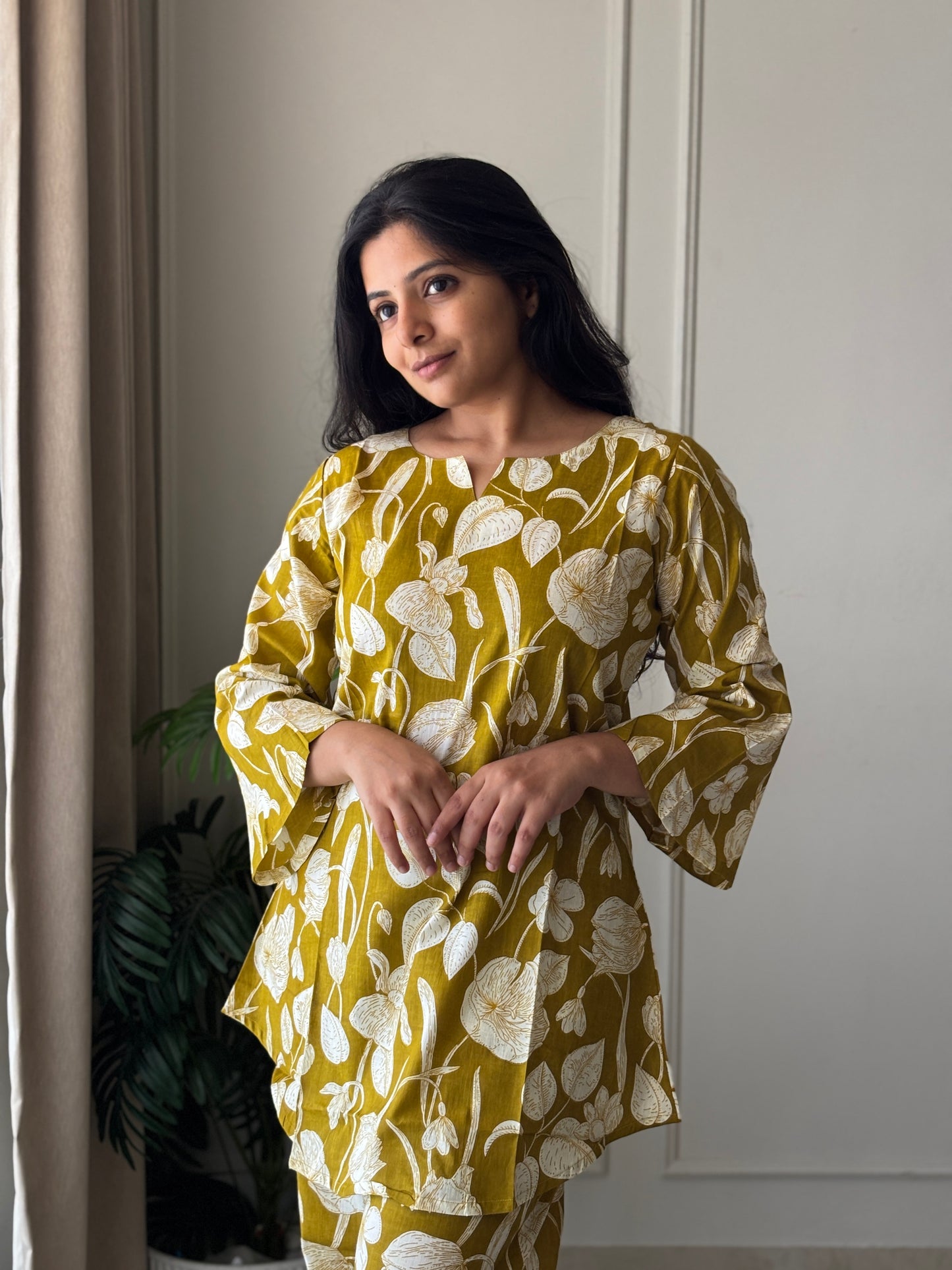 Close-up of the Heera printed cotton loungewear top showing the V-notch neckline and comfortable bell sleeve details.