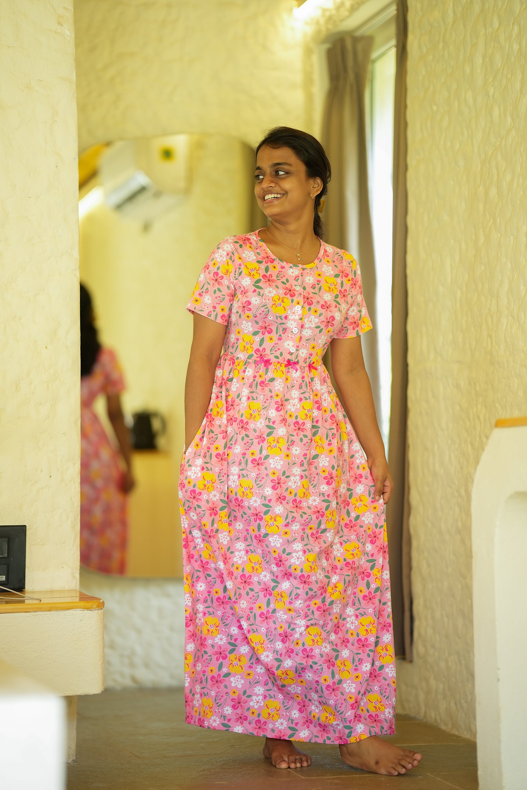 Side view of the pink cotton midi nighty showing the convenient side pocket