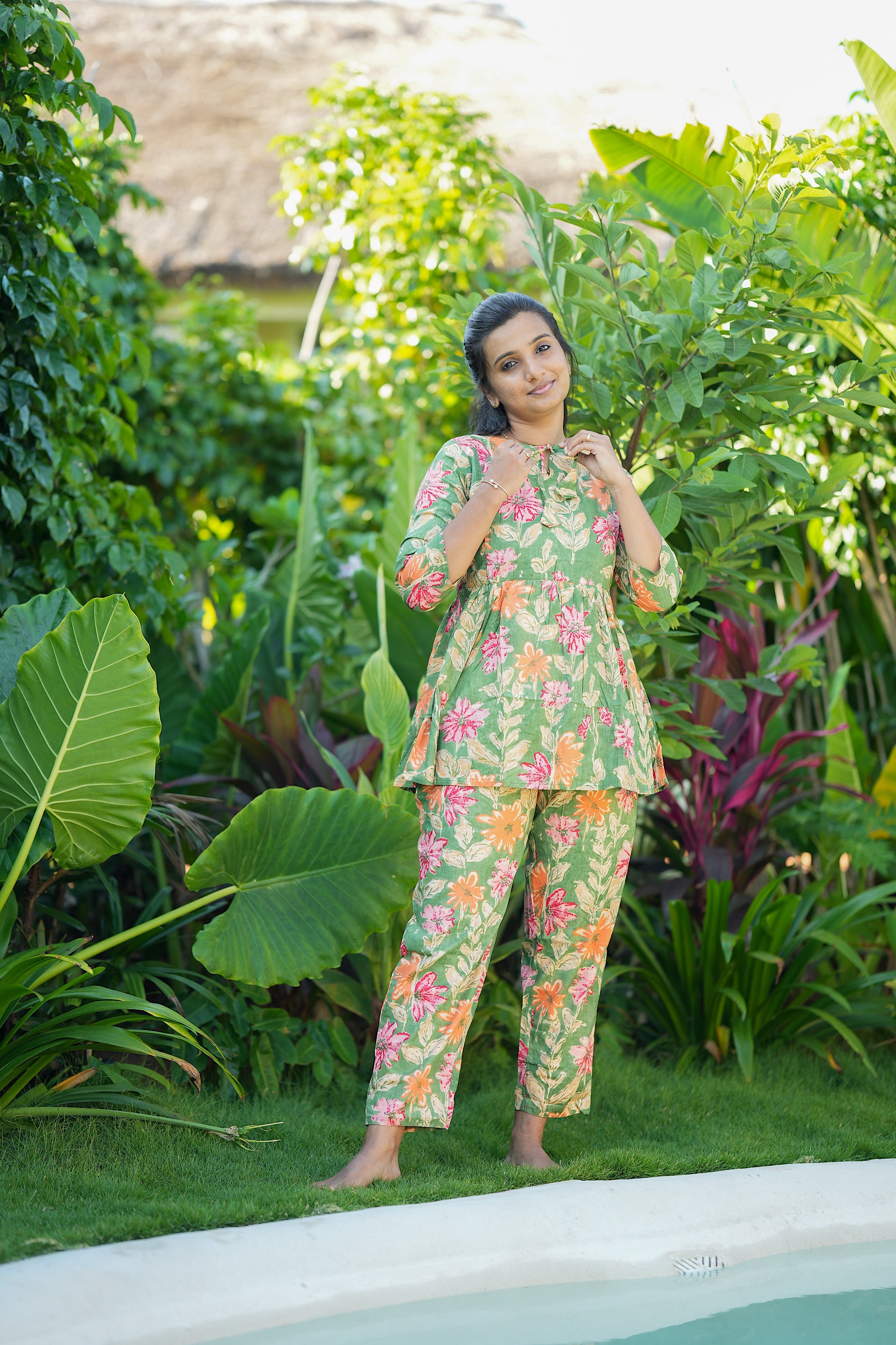 Close-up of the tie-up neck detail on the green floral peplum night suit in soft cotton fabric.