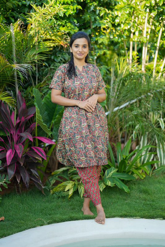 An earthy brown cotton night suit for women featuring a Kalamkari-printed tunic top and matching printed pants.