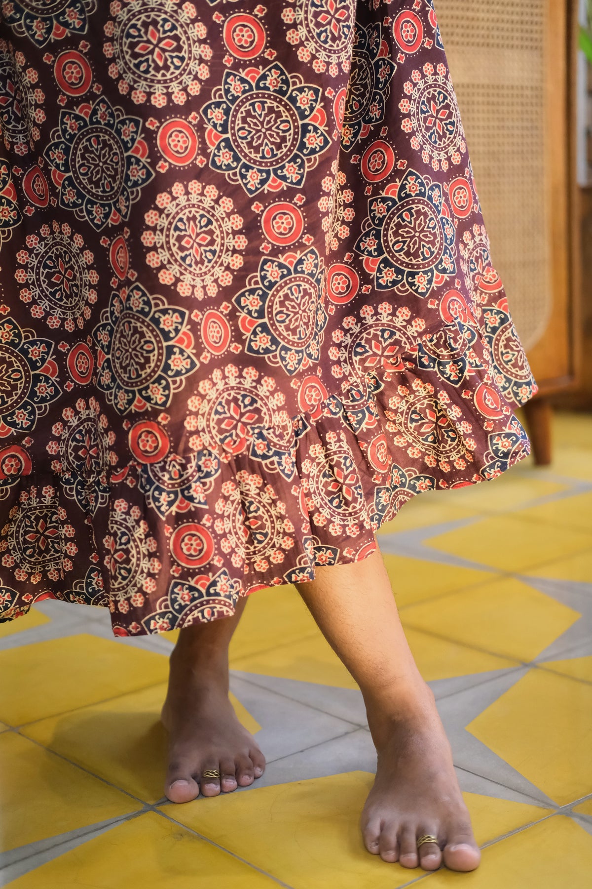 Detail of ruffled hem and cotton fabric on maroon midi nighty
