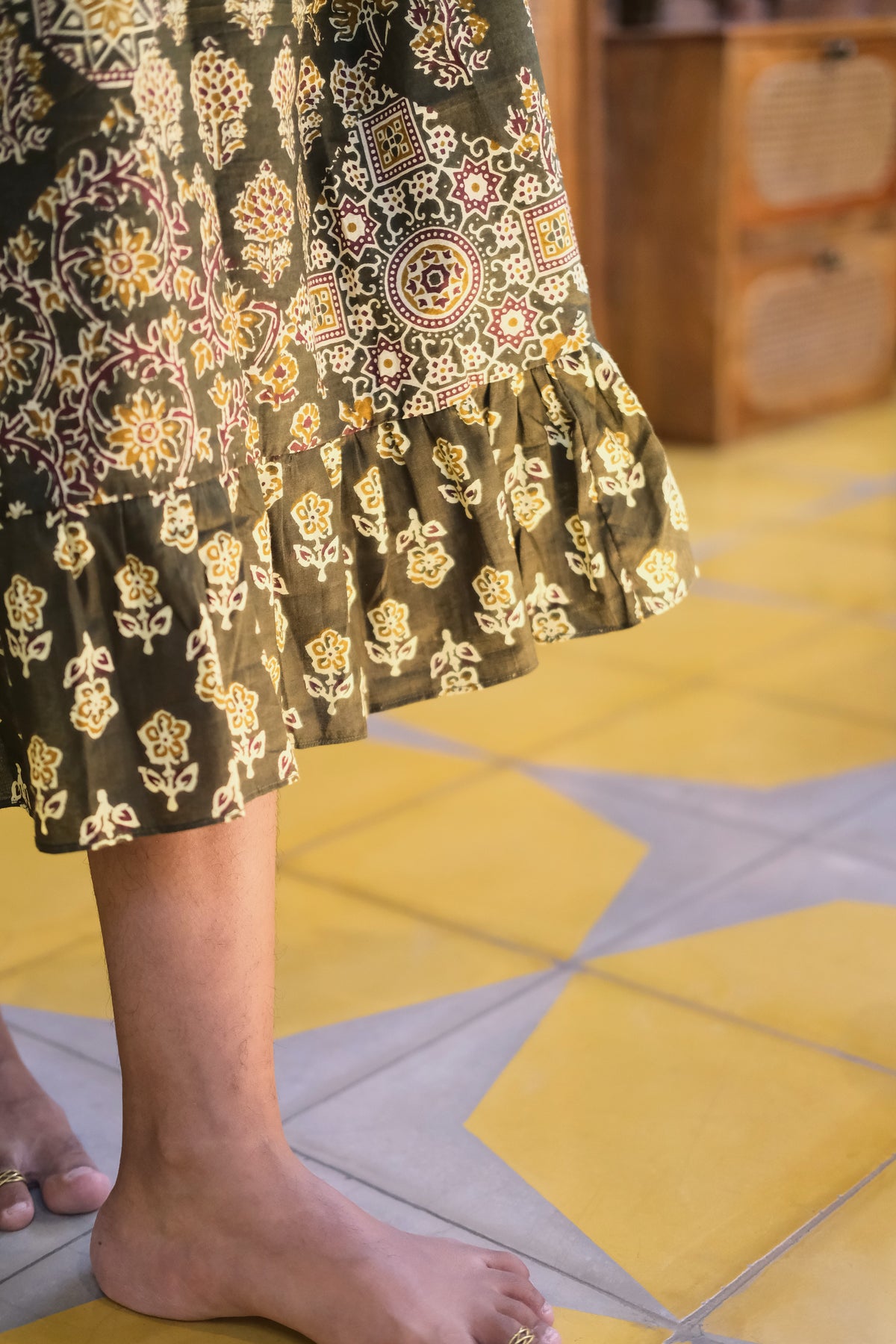 Close-up of the ruffled hemline on the olive green cotton midi nighty