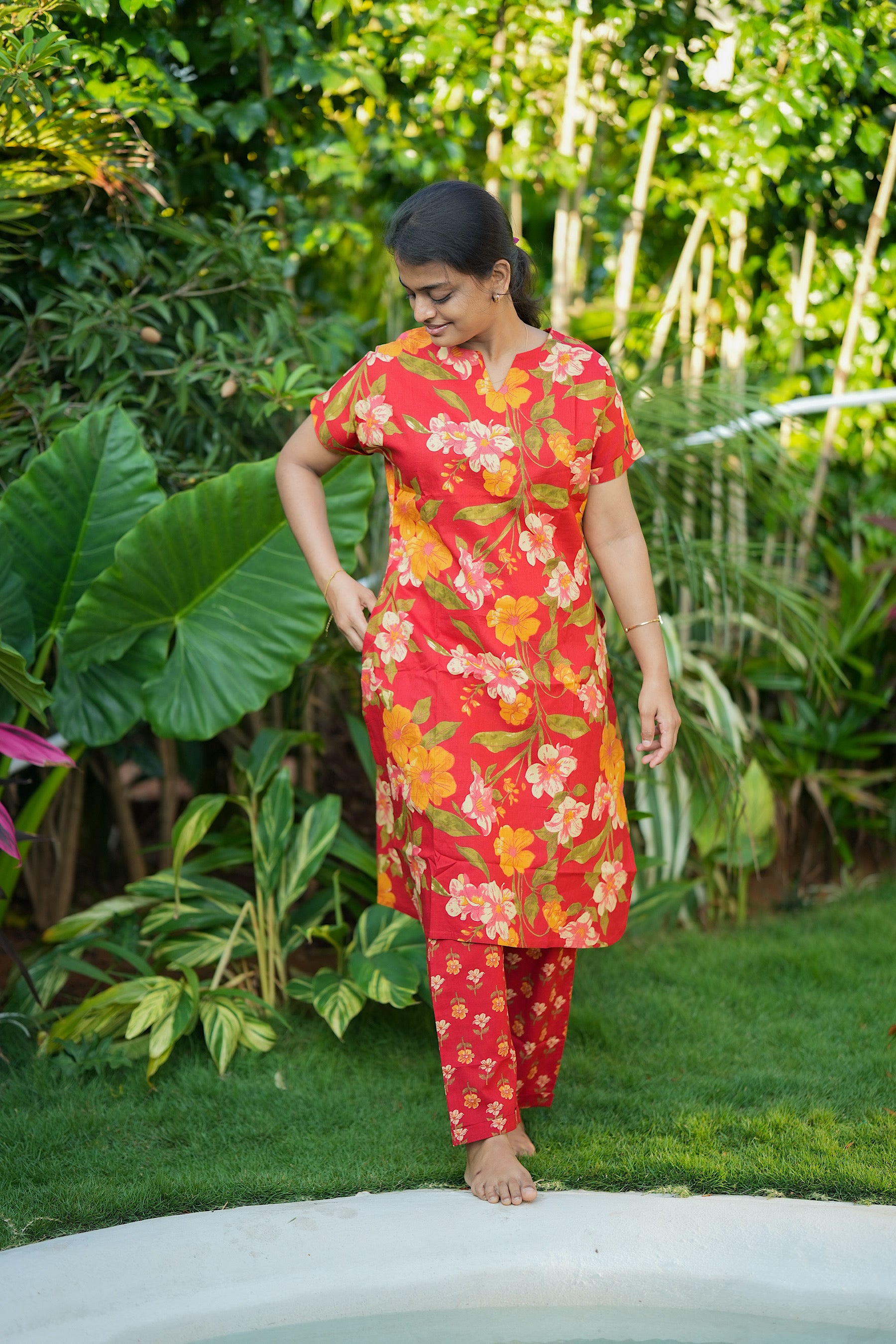 Side view of the red cotton night suit for women showing the relaxed fit and floral patterns.