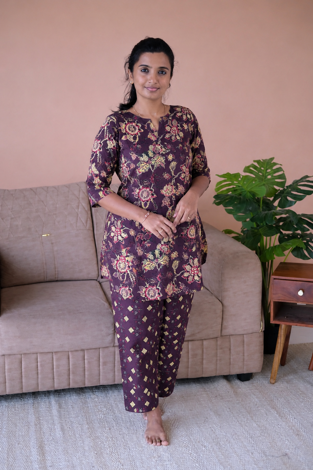 Plum purple cotton night suit for women featuring a floral printed top with 3/4 sleeves and matching geometric print pants