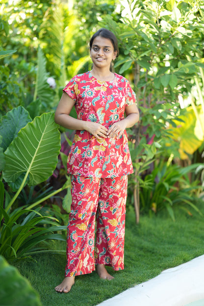 Red floral printed cotton night suit for women featuring a high neck top and matching wide-leg palazzo pants.