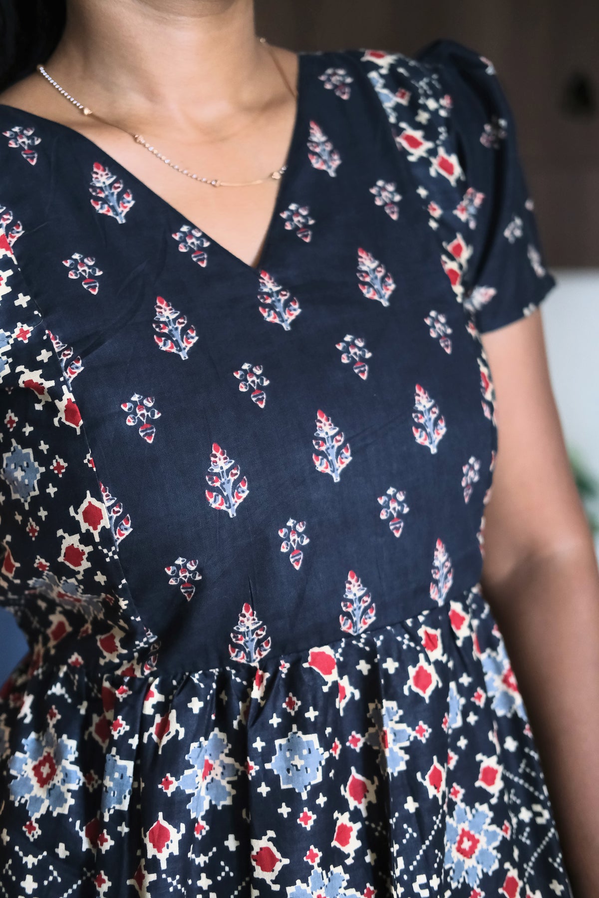 Close up of printed bodice on black cotton maxi nighty