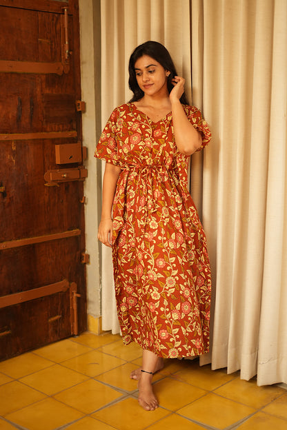 Full-length view of a comfortable midi nighty for women in rust brown floral cotton
