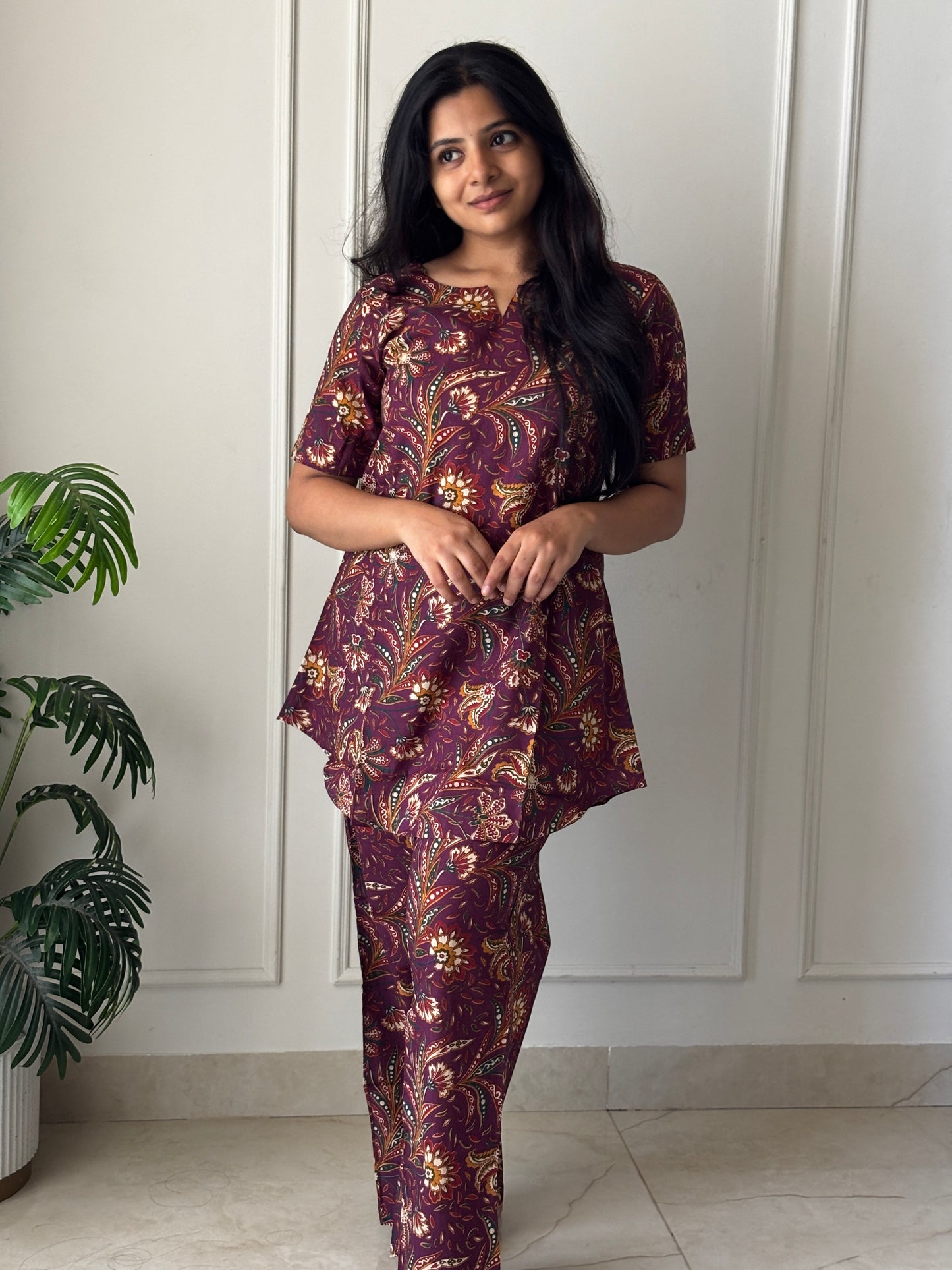 Wine purple printed cotton night suit for women featuring a short-sleeved tunic top and matching relaxed-fit pants.