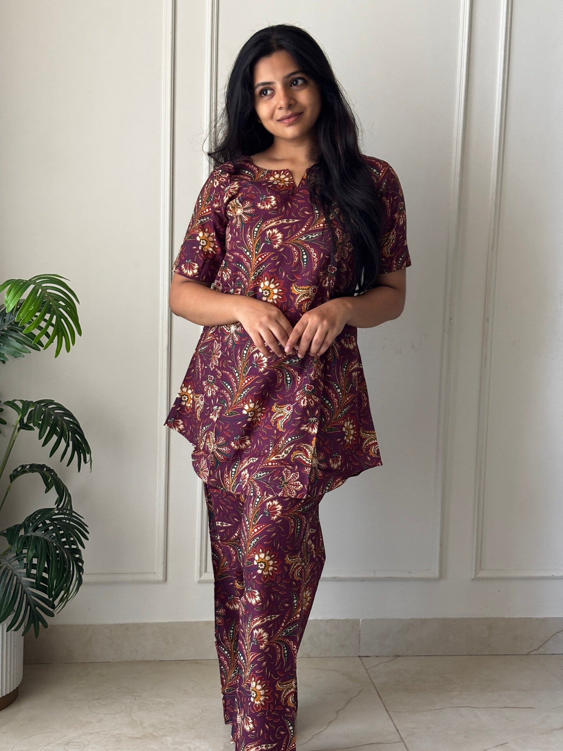 Wine purple printed cotton night suit for women featuring a short-sleeved tunic top and matching relaxed-fit pants.