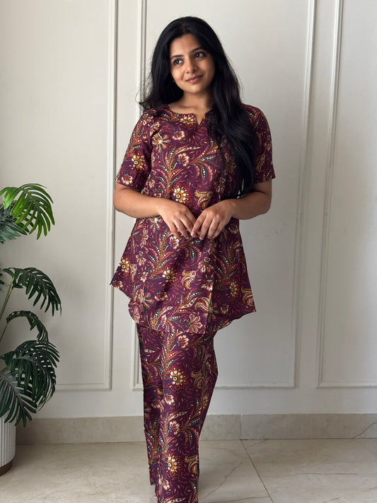 Wine purple printed cotton night suit for women featuring a short-sleeved tunic top and matching relaxed-fit pants.