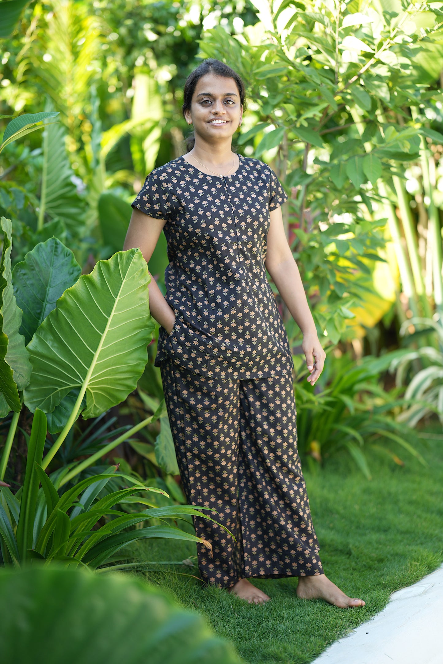 Close-up of the black cotton night suit showing the functional side pocket on the tunic top.