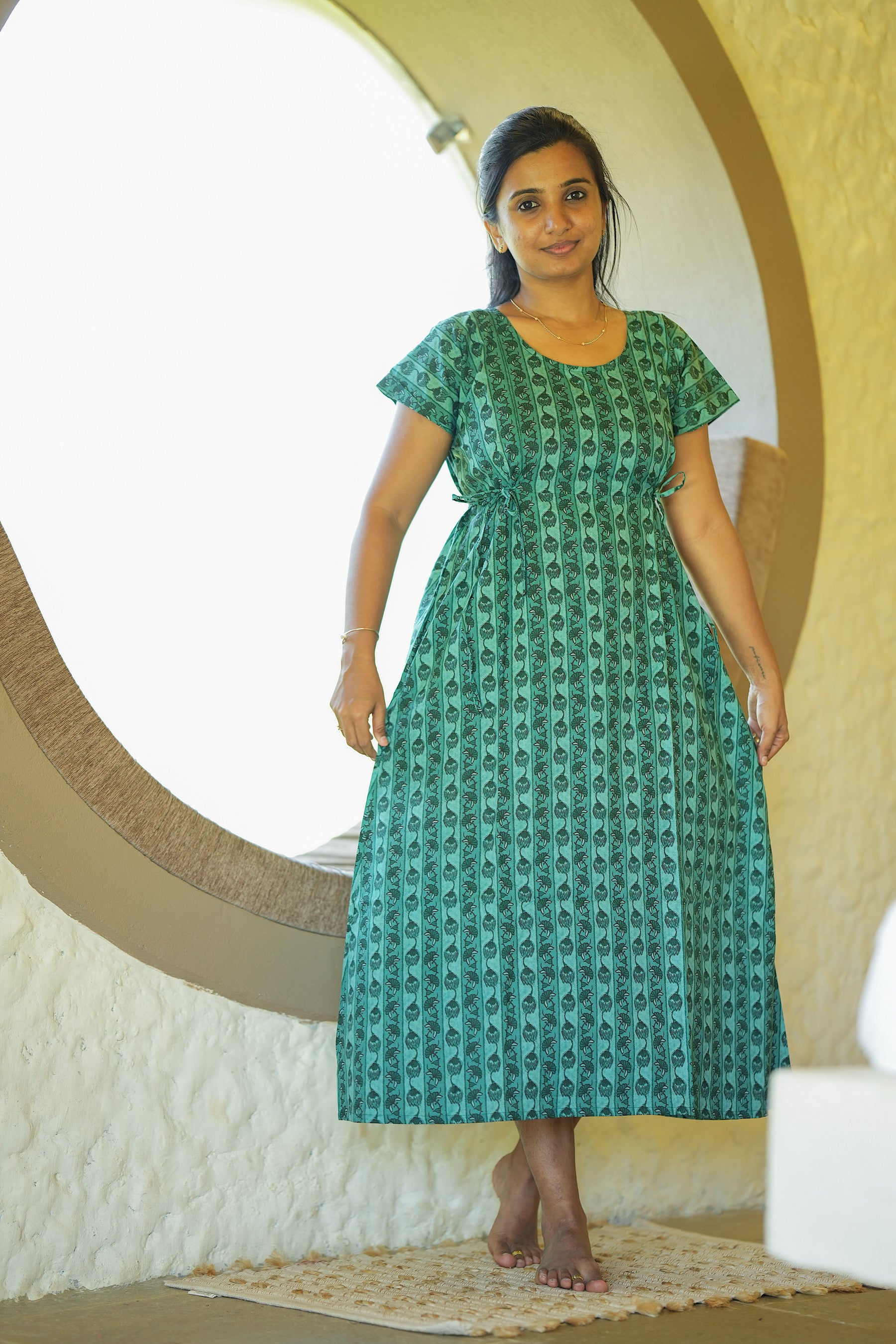 Comfortable green cotton nighty featuring a round neck and adjustable side ties.