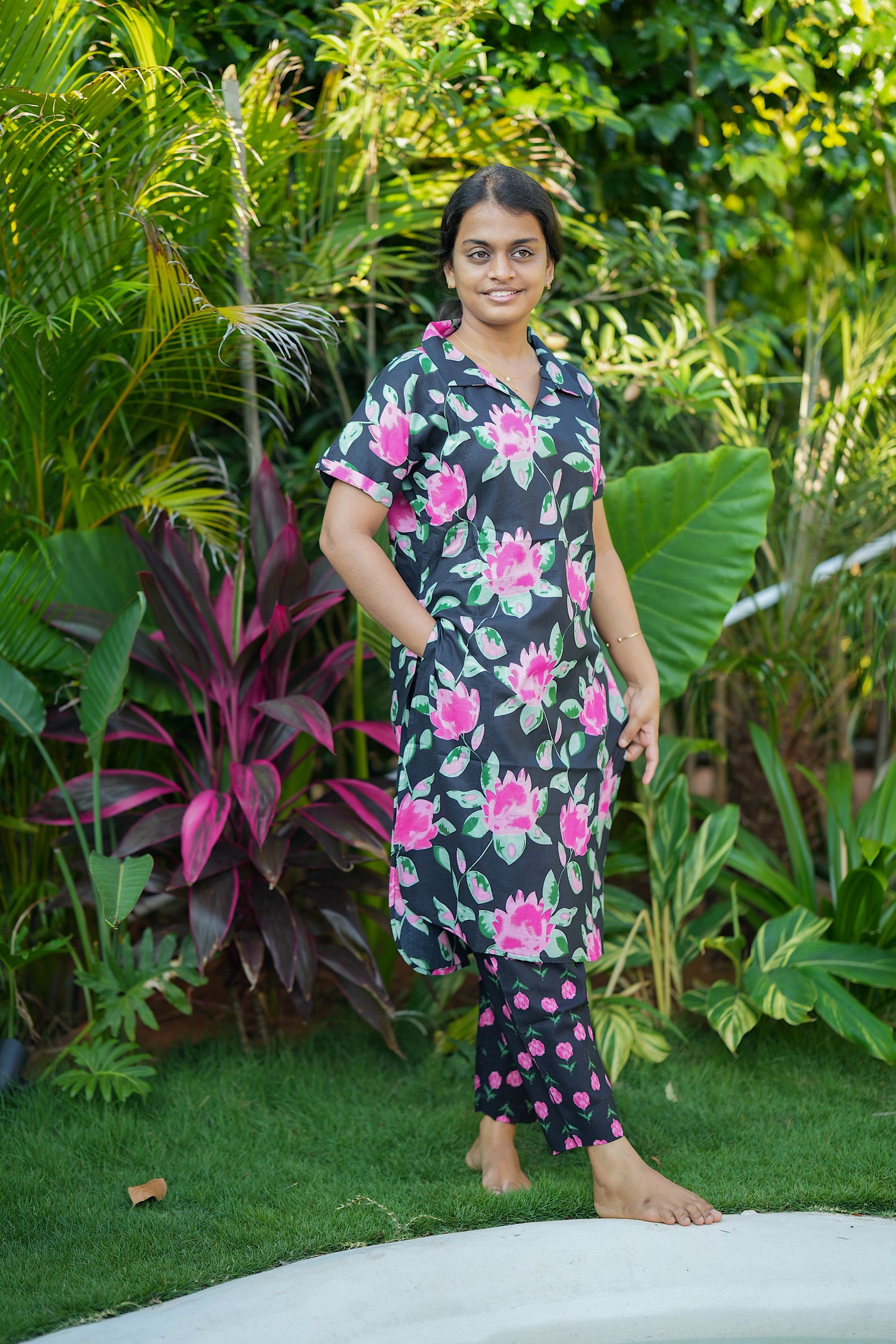 Comfortable black floral print nightwear for women with a collared top and pockets.