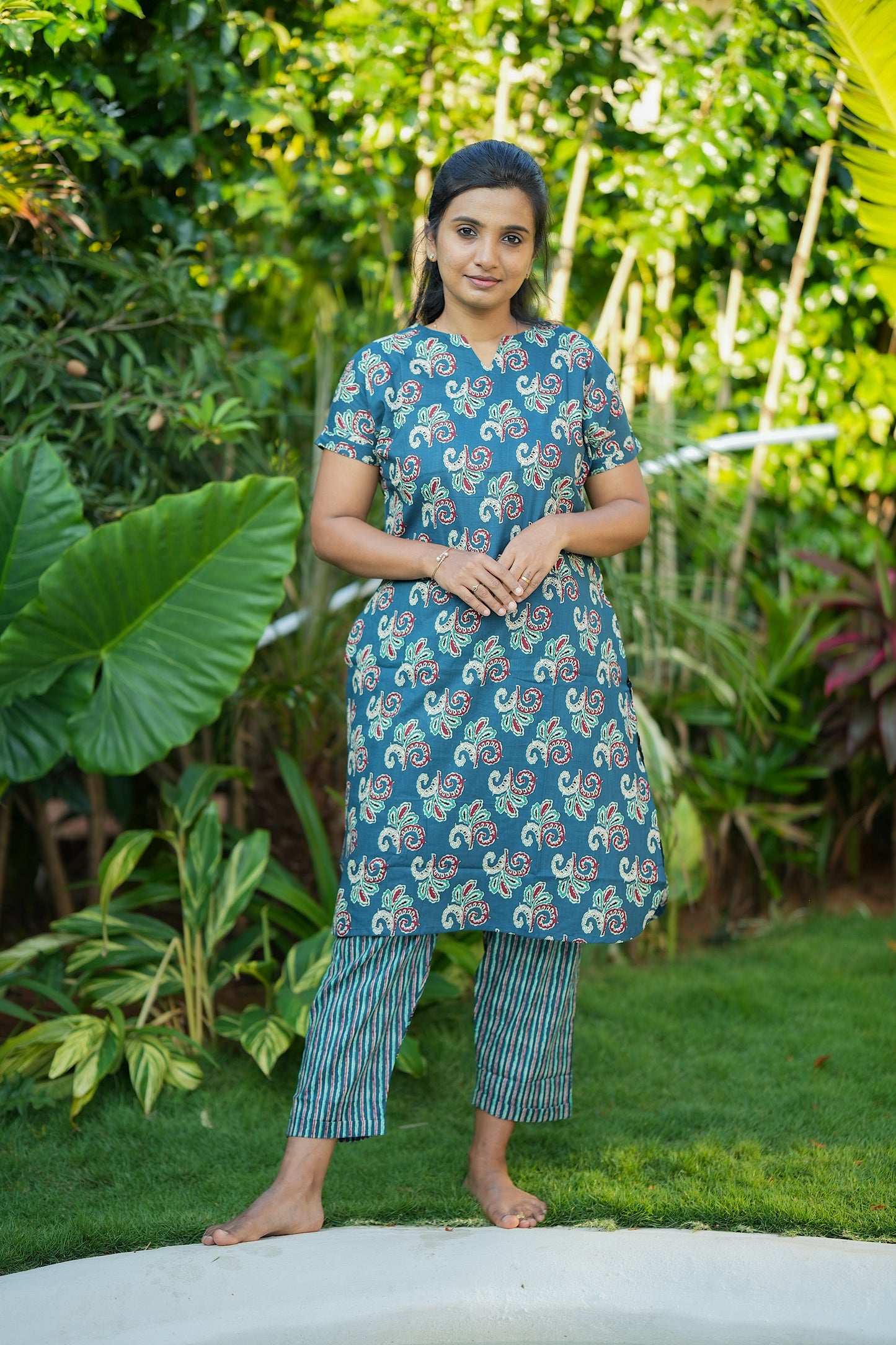 Full-length view of the Krithi cotton night suit for women in teal green with traditional block prints and striped trousers.