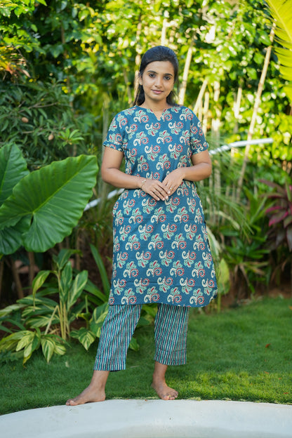 Full-length view of the Krithi cotton night suit for women in teal green with traditional block prints and striped trousers.