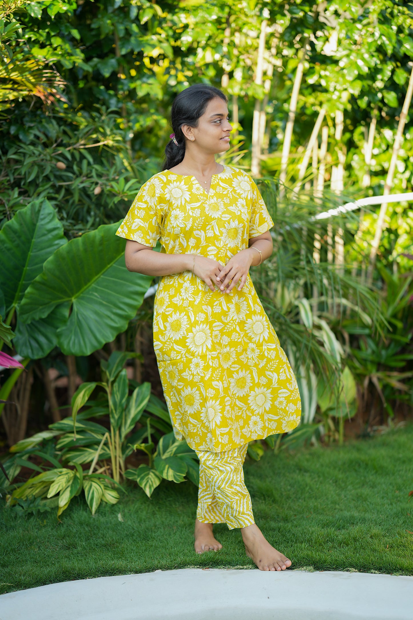 Side view of the yellow cotton night suit for women showing the comfortable drape and short sleeve design.