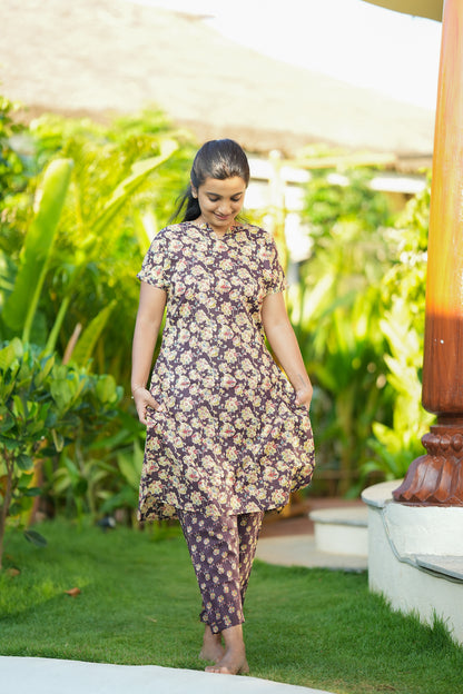 A comfortable printed night suit in violet cotton with a relaxed fit top and straight pants from Mullai Nightwear.