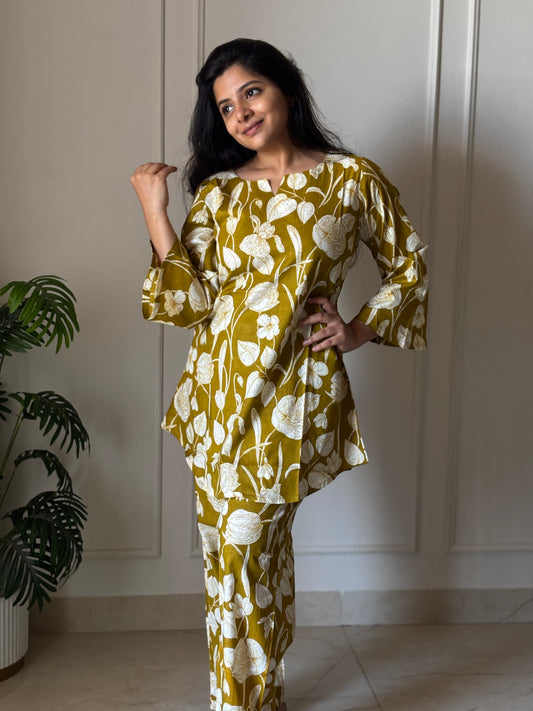 Olive mustard cotton night suit for women featuring a white floral print, bell sleeves, and matching relaxed-fit pants.
