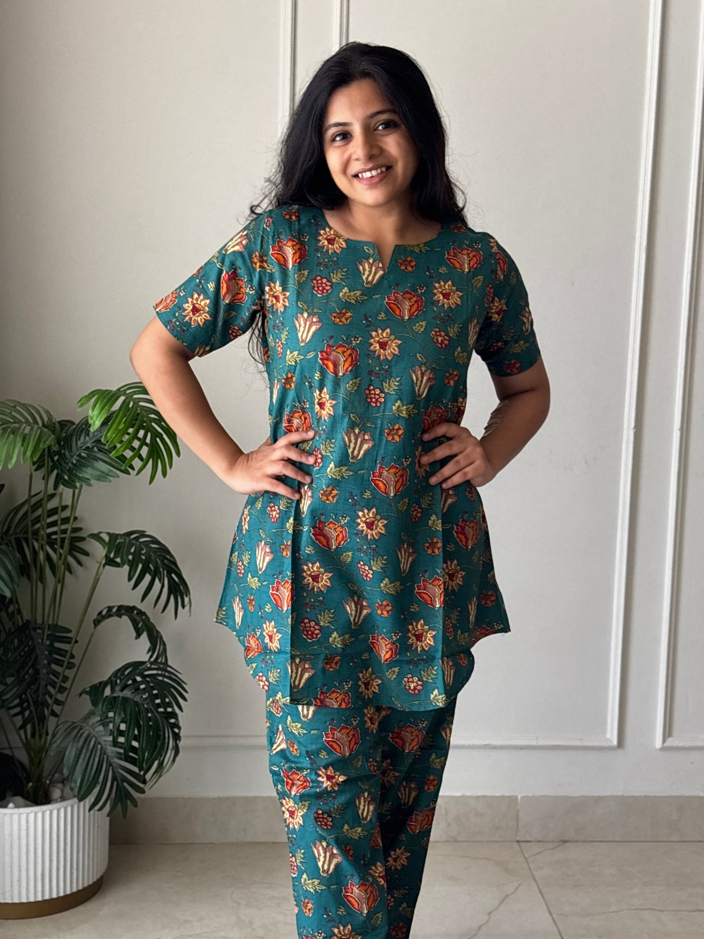 Teal blue printed cotton night suit for women featuring a tunic top with short sleeves and matching straight-fit pants.
