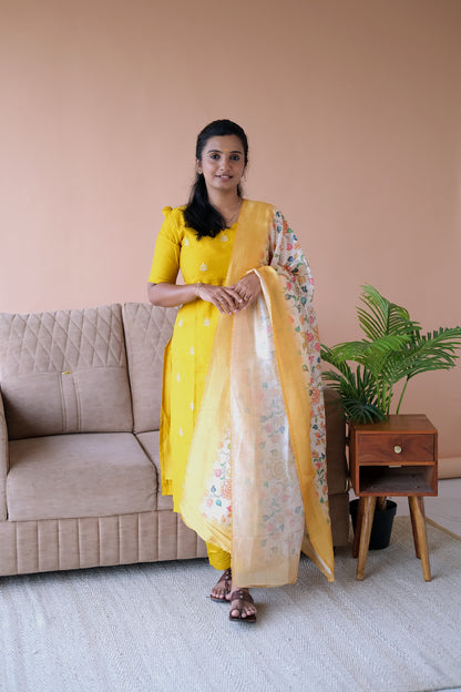 Full-length view of the yellow silk kurti set with dupatta showing the elegant drape of the floral kalamkari-style dupatta.