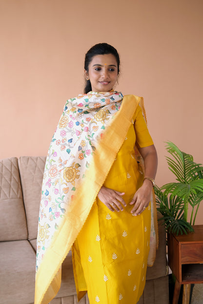 Close-up of the scallop neck design and elbow sleeves on the yellow silk kurti set with dupatta.