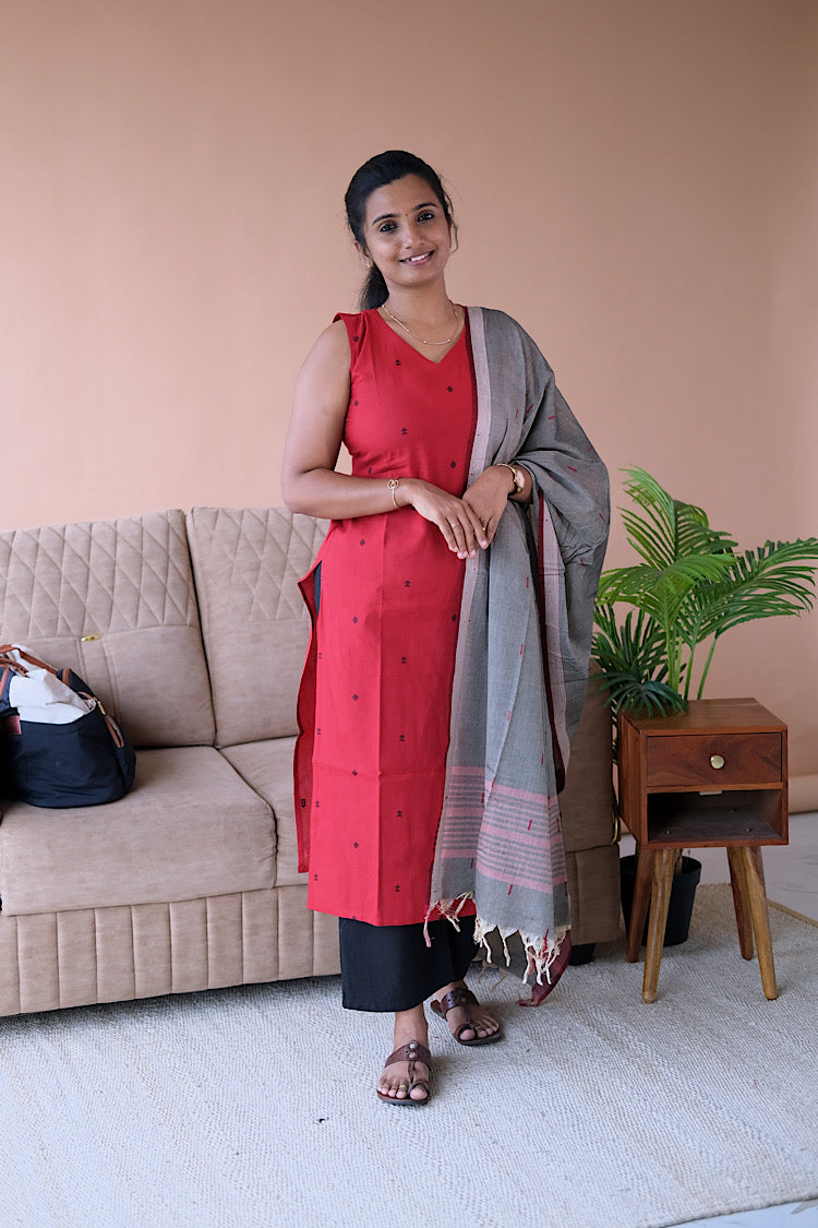 Manasa red cotton salwar set featuring a sleeveless straight kurti with black bootta motifs paired with black pants and grey dupatta