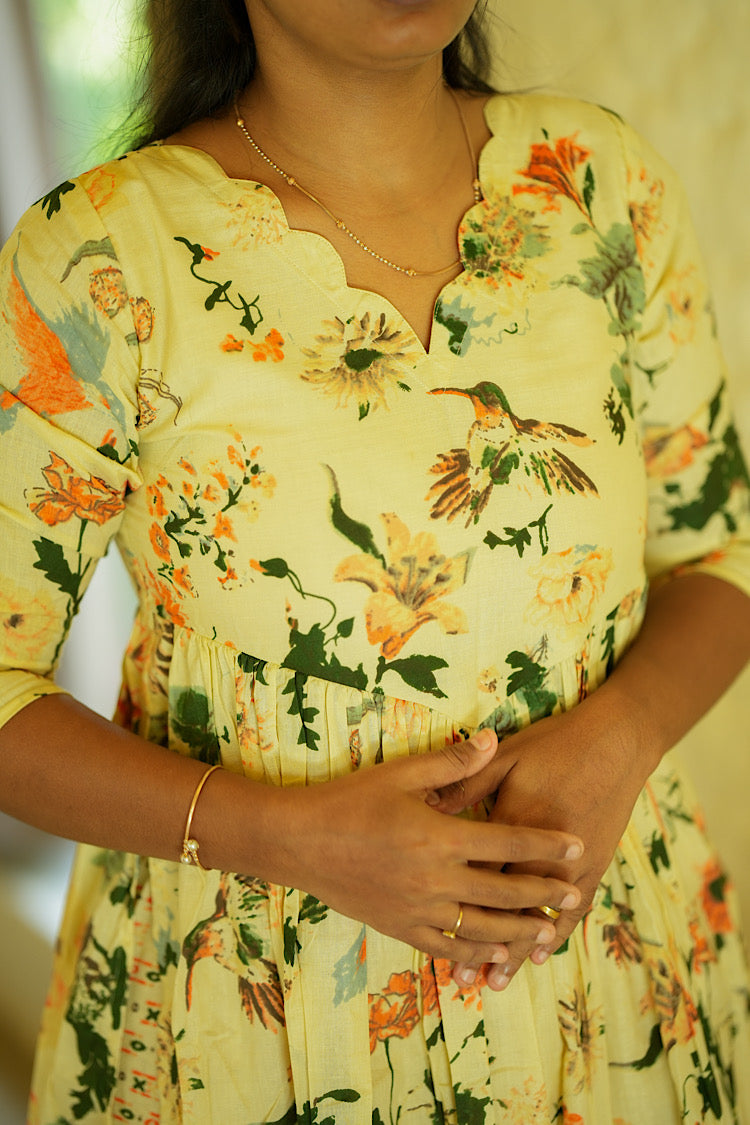 Close up of the scalloped V-neck and gathered waist on the yellow Alia cut kurti set