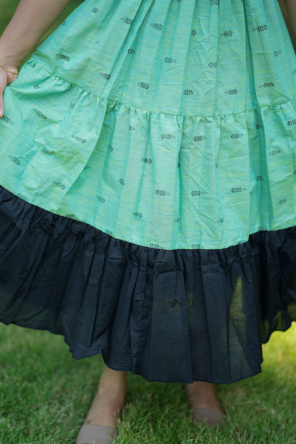 Close-up of the tiered skirt showing the contrast solid black gathered hem