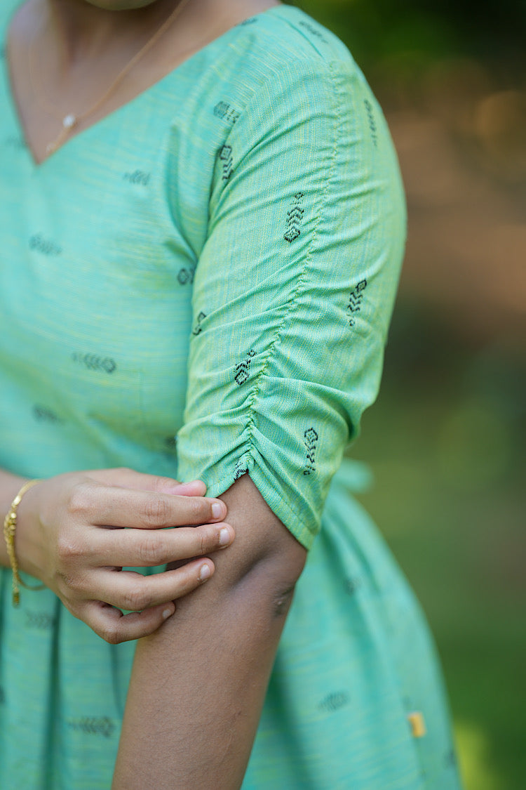 Close-up of the unique ruched detailing on the elbow-length sleeves