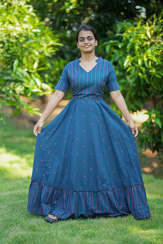 Deep blue cotton maternity dress with red geometric prints, featuring a V-neck, stand collar, and ruffled hem.