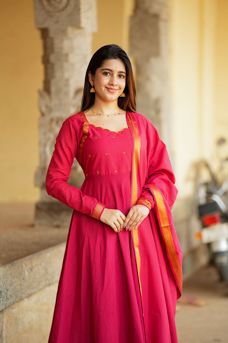 Mid-shot of the red anarkali dress with dupatta highlighting the scalloped neckline and gold embroidered yoke.