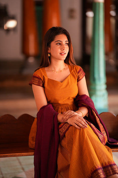 Close up of sweetheart neckline and check pattern on mustard kurti