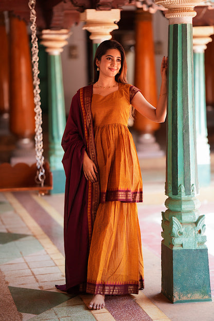Front view of mustard yellow sharara set with cap sleeves