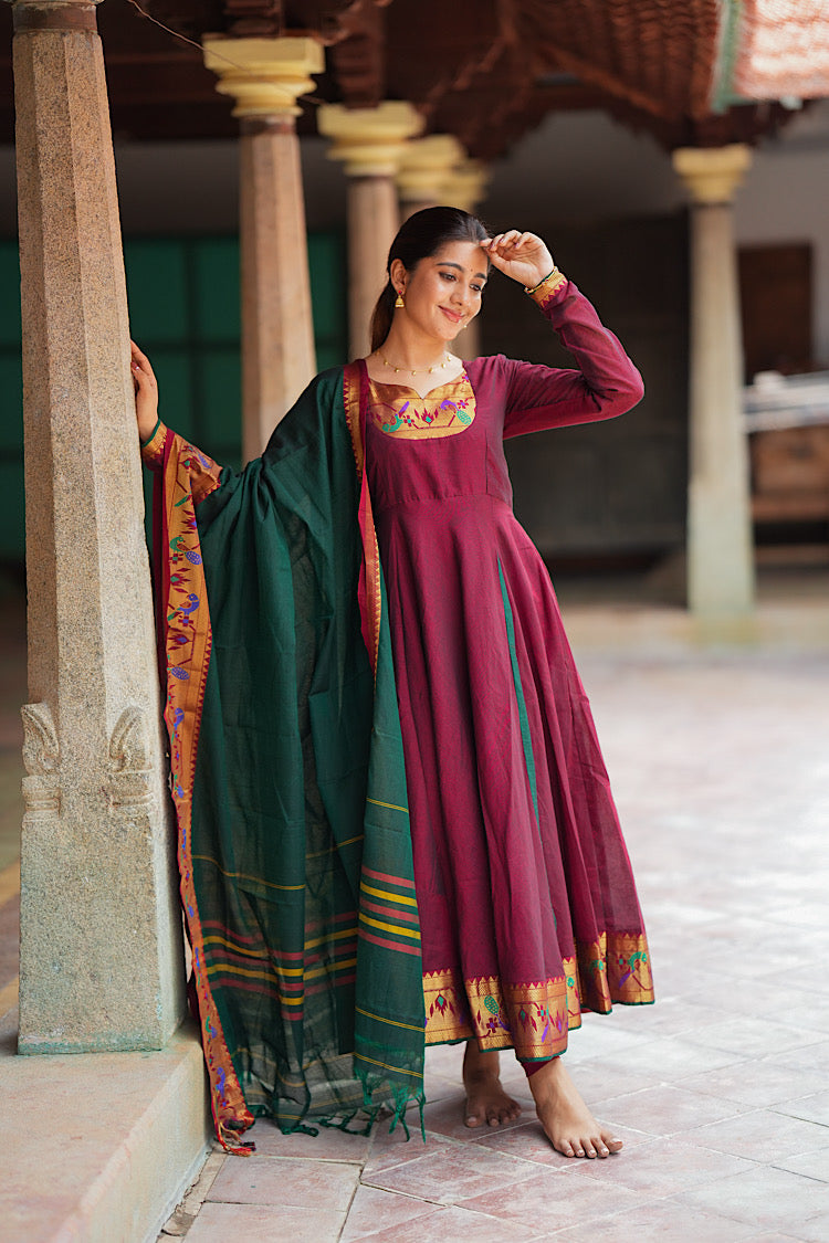 Full-length view of the flared maroon and green side-panel cotton anarkali suit set.