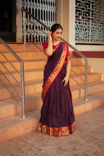Elegant drape of the maroon pleated skirt and red crop top set