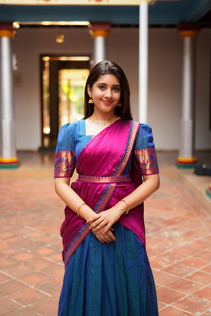 Peacock blue pleated maxi dress styled with a magenta dupatta draped across the front.