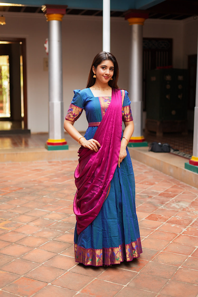 Peacock blue pleated dress with a magenta dupatta draped in a cowl style.